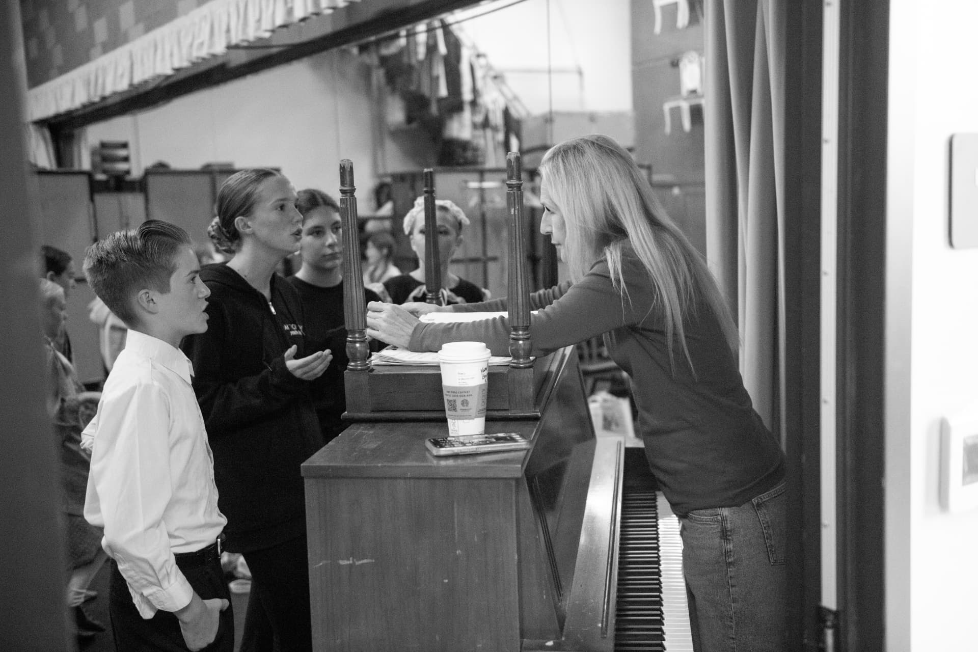 Stacy coaching young singers from the piano
