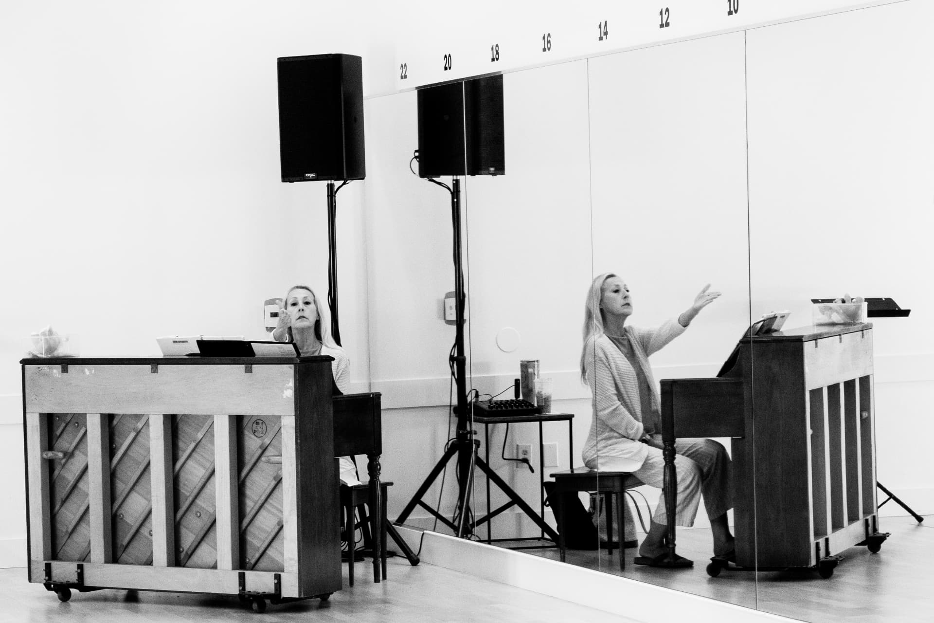 Stacy conducting from the piano in the rehearsal studio